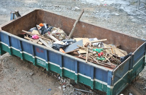Wait and Load Skip Hire service in Mill Hill setting up a skip.