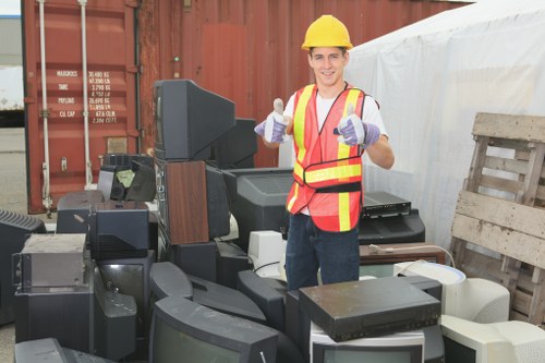Staff sorting recyclable materials at a recycling facility in Mill Hill